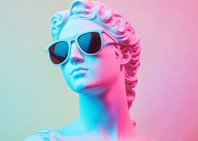 white-marble-bust-woman-wears-sunglasses-against-pink-blue-background